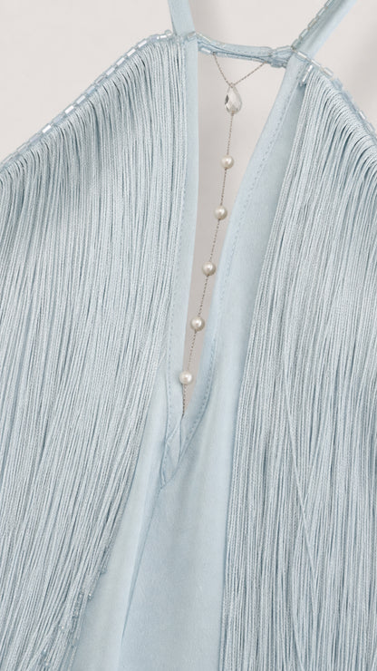 Close-up detail of halter neckline, beading, and fringe on Light Blue dress