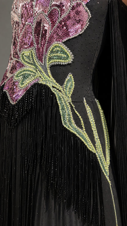 Close-up detail of sequin floral embroidery and fringe on black gown