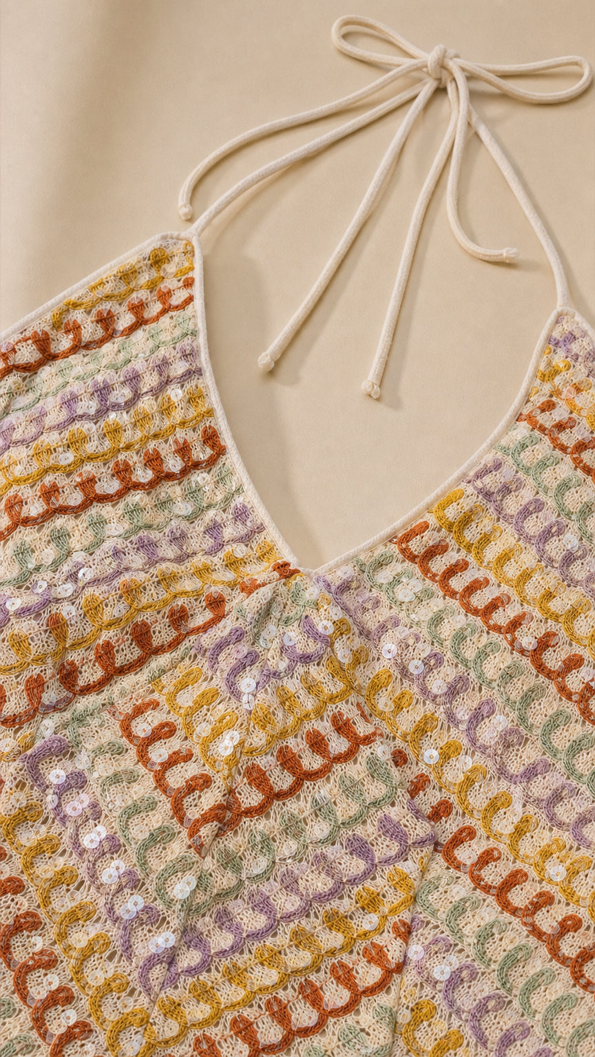 Close-up detail of textured chevron knit pattern and halter neckline