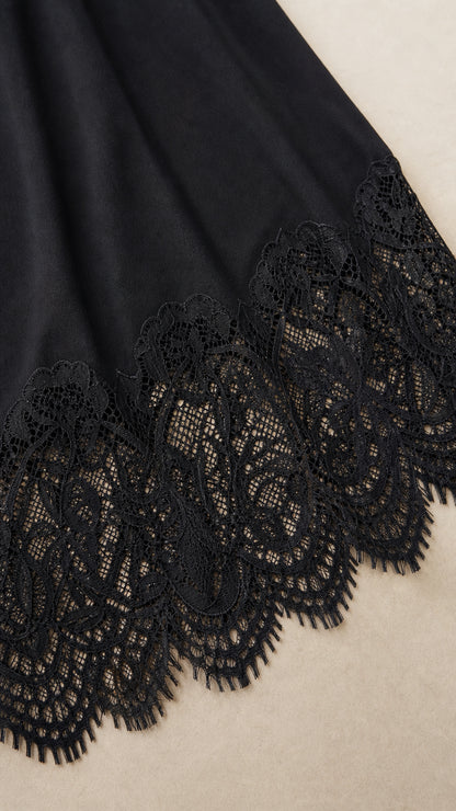 Close-up detail of the intricate black lace hem