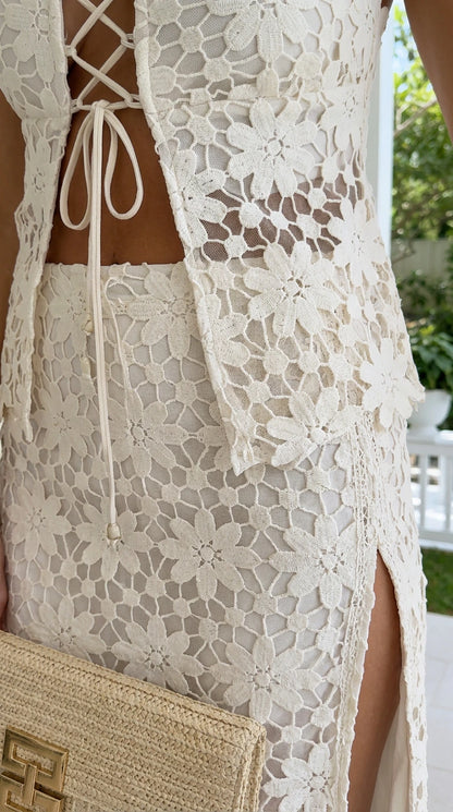 Close-up of lace-up back and floral lace texture on white set