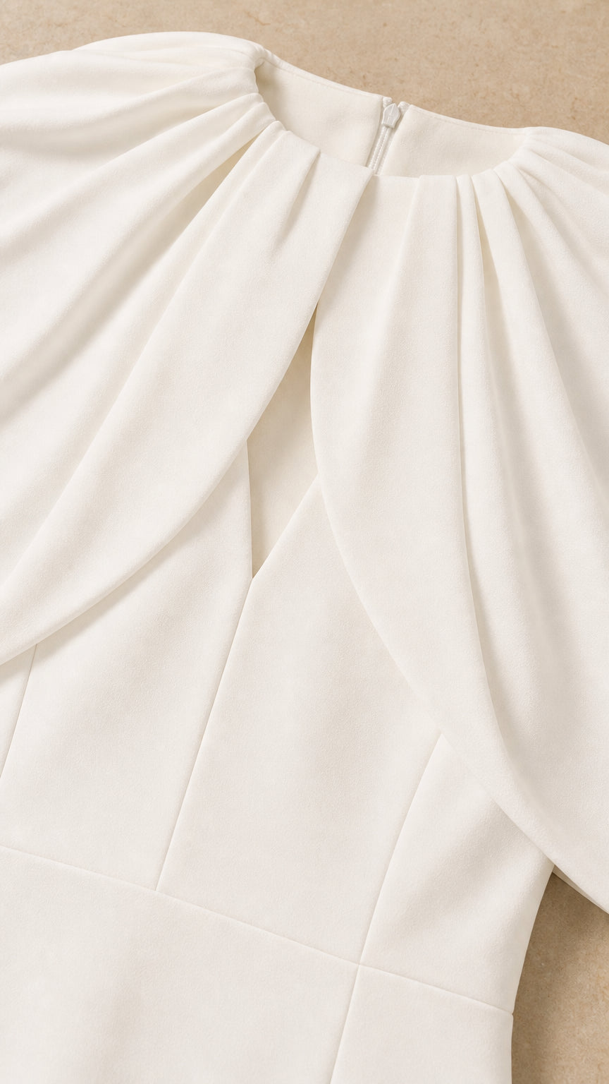 Close-up of pleated collar and keyhole detail on white dress