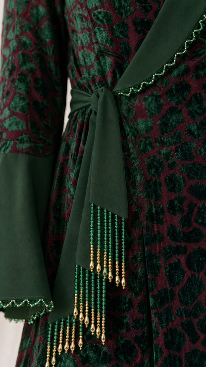 Detailed close-up of beaded fringe belt, shawl lapel trim, and textured jacquard pattern