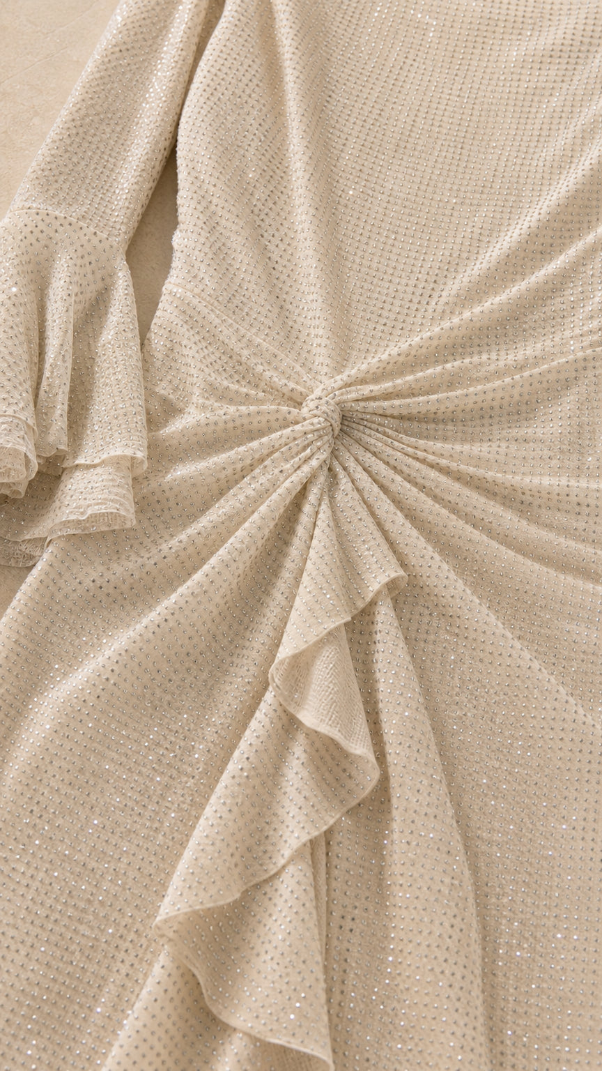 Close-up of shimmer fabric and waist knot ruffle detail