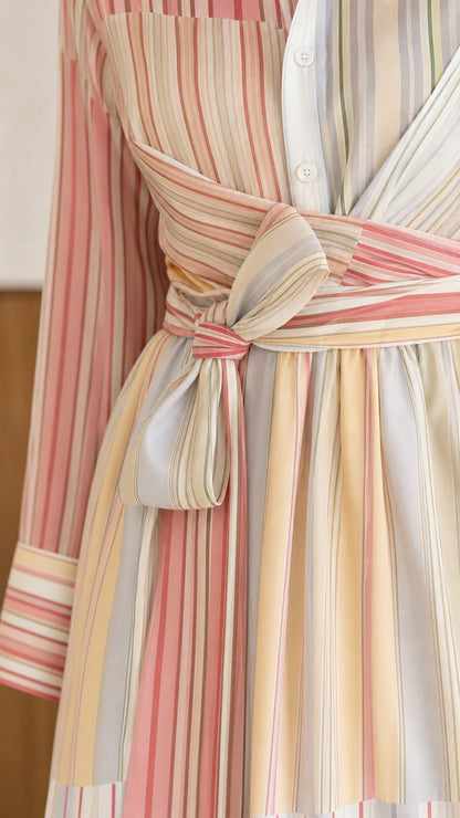 Close-up detail of crossover wrap tie waist and striped fabric pattern