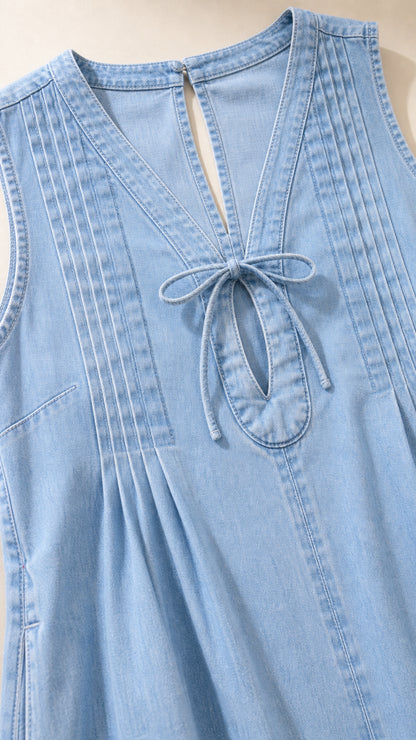 Close-up detail of front tie and pleats on light blue dress