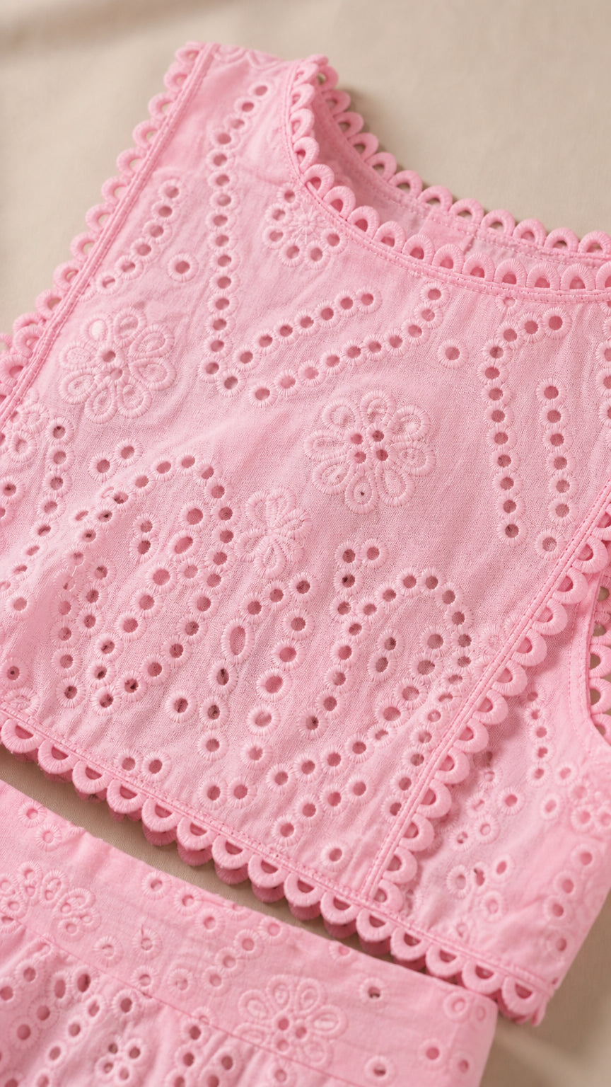 Close-up detail of pink eyelet crop top and skirt texture
