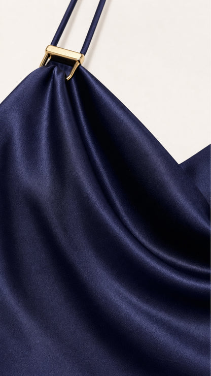 Close-up of the smooth navy satin-look fabric and strap detail