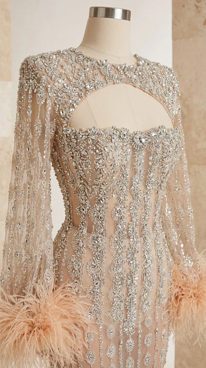 Close-up of champagne beaded bodice with keyhole cutout and feather cuff sleeve