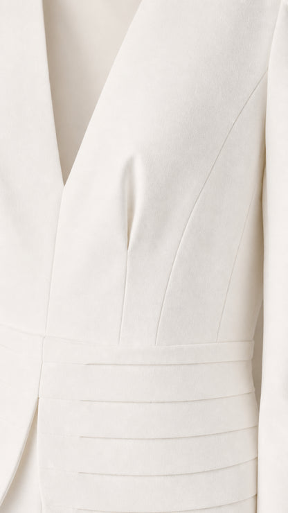 Close-up detail of structured pintuck peplum waist and V-neckline