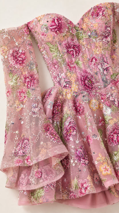 Close-up detail of floral embroidery and bell sleeves
