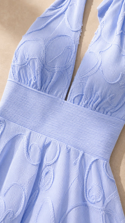 Close-up detail of the plunging neckline and ribbed waistband