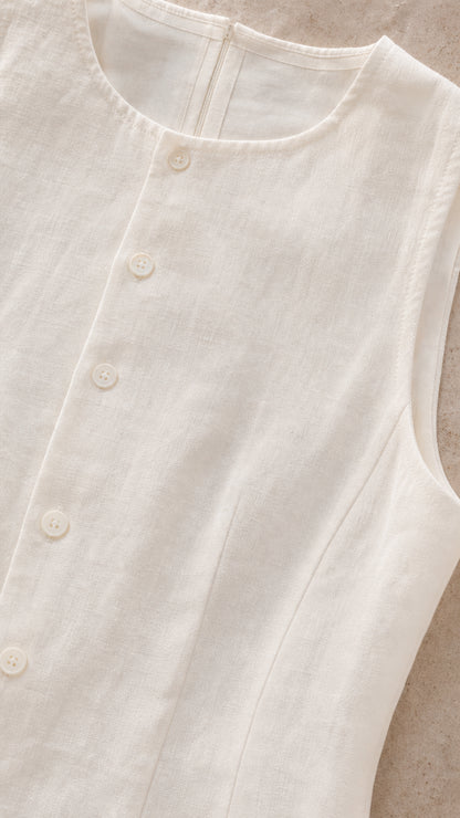 Close-up detail of white blouse front button closure and fabric texture