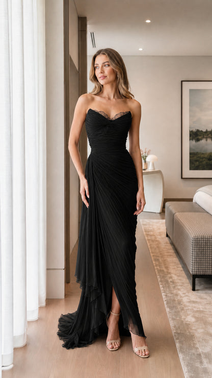 Front view of woman wearing black strapless ruched evening dress
