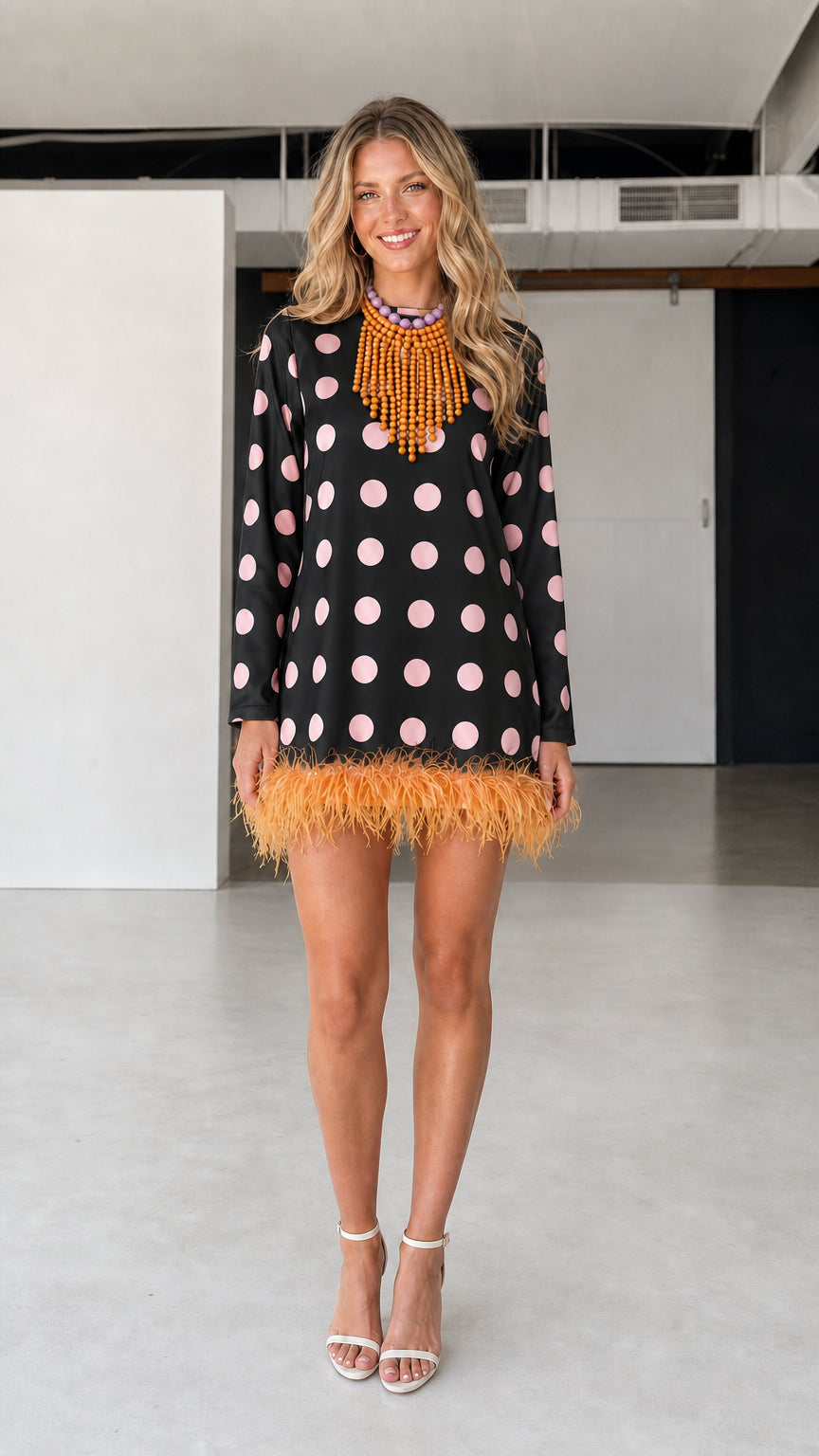 Model wearing black polka dot feather hem dress