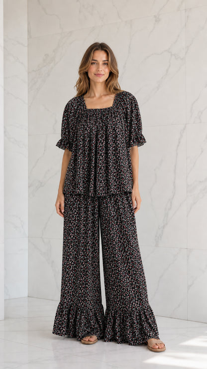 Model wearing black ditsy floral two-piece wide-leg pants set