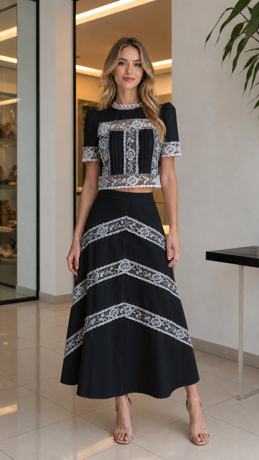 Full-body view of woman wearing black lace crop top and matching skirt set