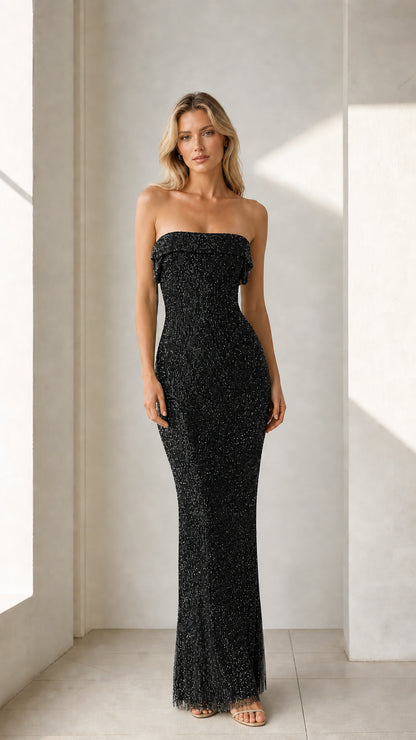Model wearing black glittering strapless maxi dress
