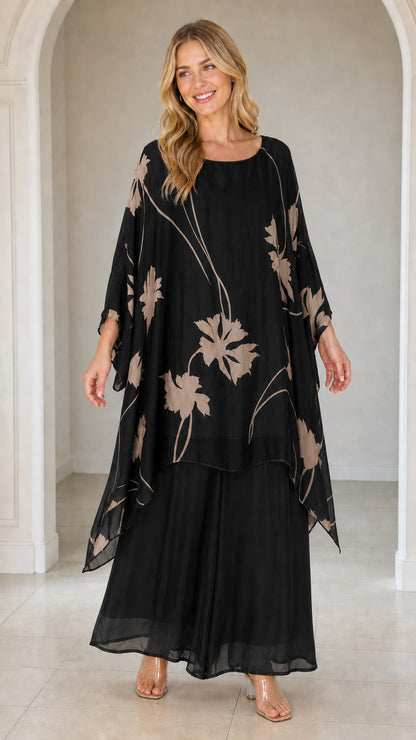 Front view of woman wearing black floral kaftan set