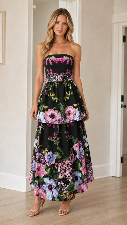 Woman wearing black floral strapless tiered maxi dress