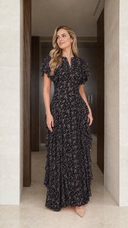 Model wearing black floral ruffle maxi dress