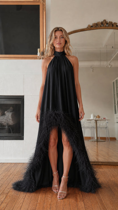 Front view of model wearing black feather hem high neck maxi dress