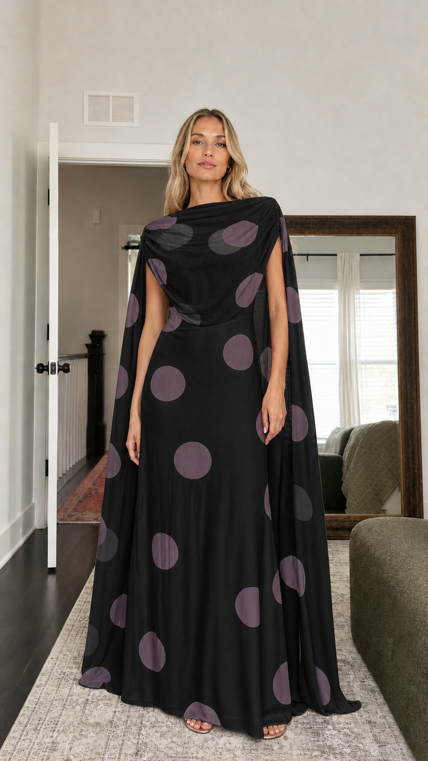 Model wearing black polka dot cape maxi dress