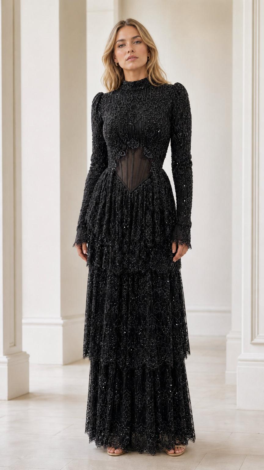 Model wearing black high neck beaded long sleeve tiered evening gown