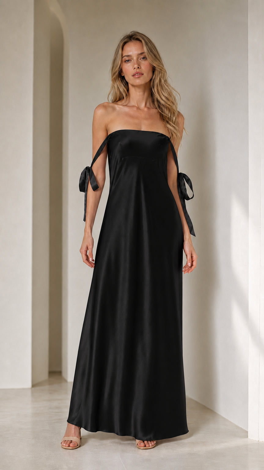 Model wearing black satin strapless maxi dress