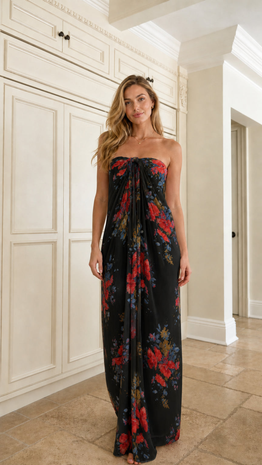 Front view of woman wearing black floral strapless maxi dress