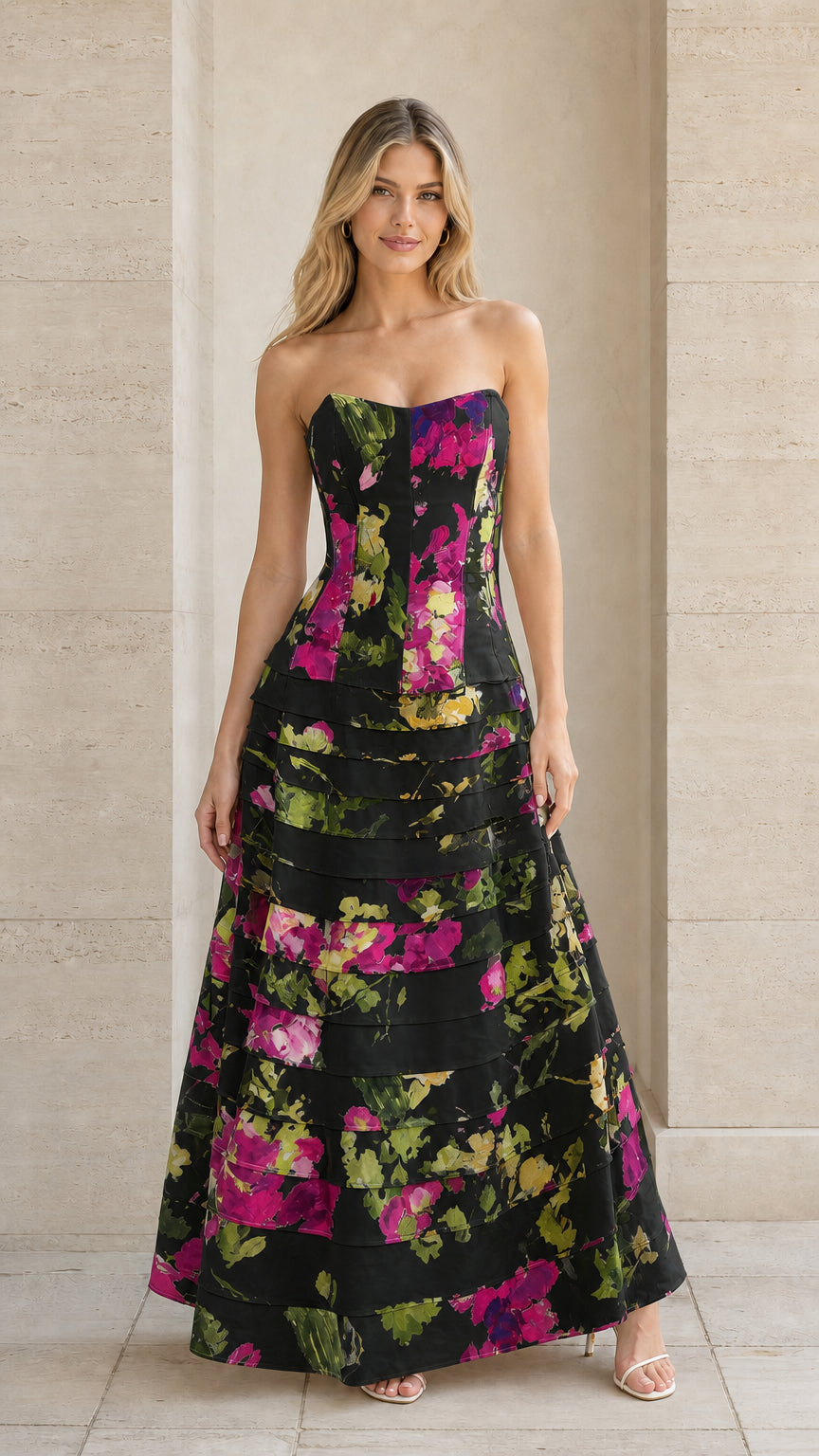 Model wearing black floral strapless tiered formal maxi gown
