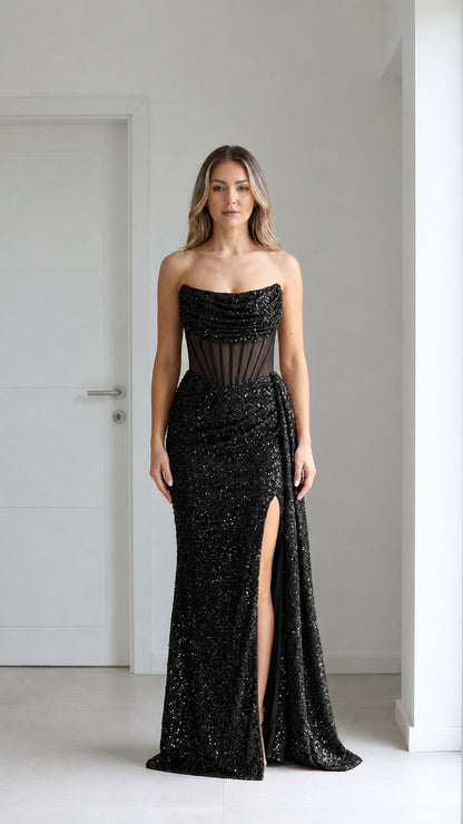 Front view of black sequin evening gown with high slit