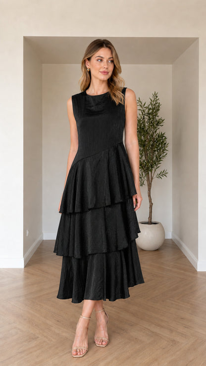 Model wearing black sleeveless tiered asymmetric midi dress