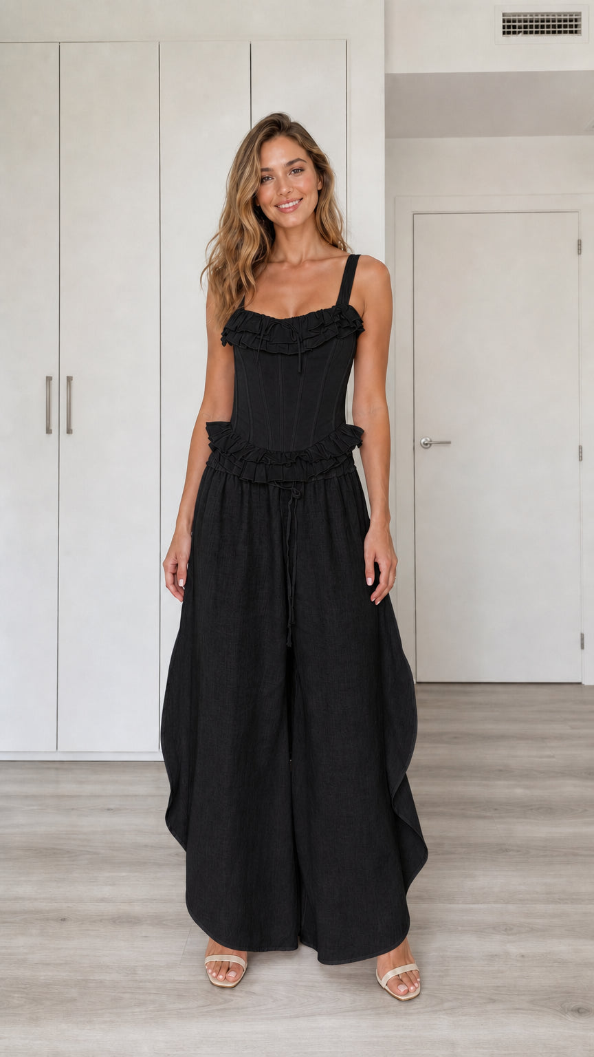 Model wearing black ruffled corset top and wide-leg pants set