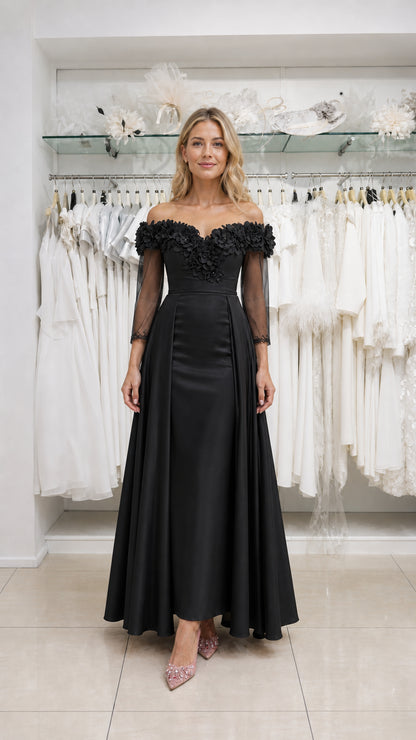 Model wearing black off-the-shoulder evening dress