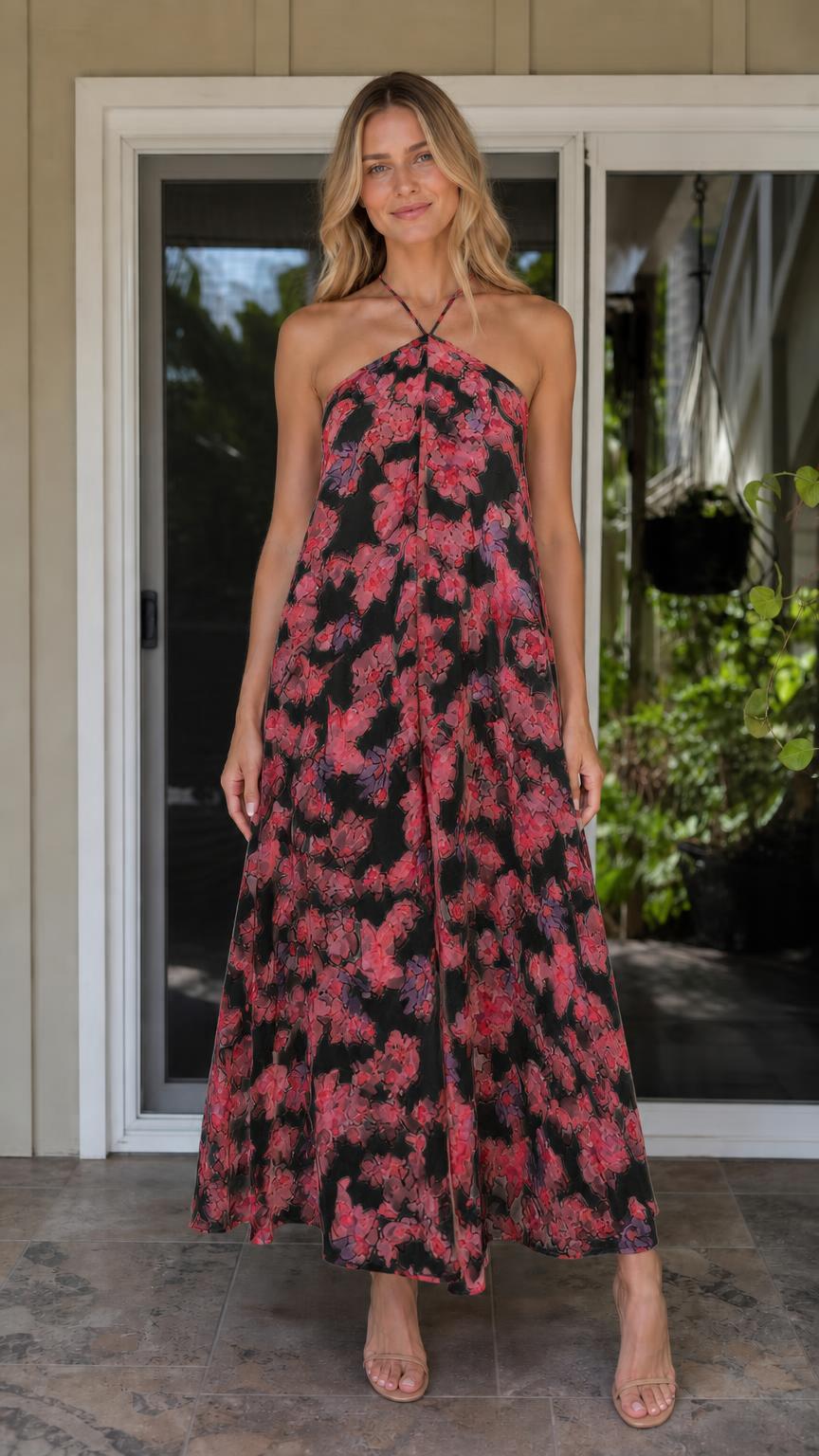 Model wearing black floral print halter maxi dress