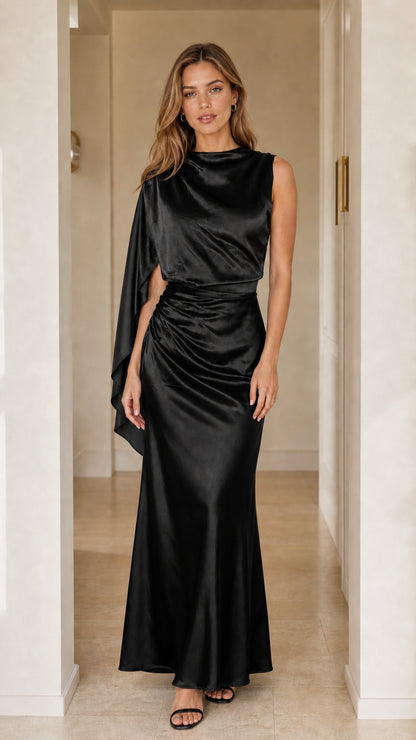 Front view of black asymmetric cape sleeve satin maxi gown