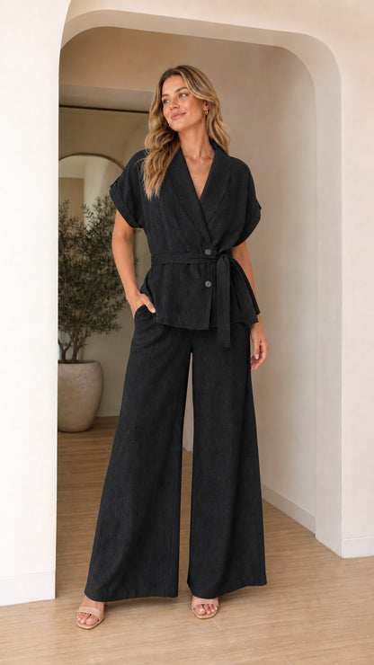 Model wearing black two-piece blazer and wide leg pants set