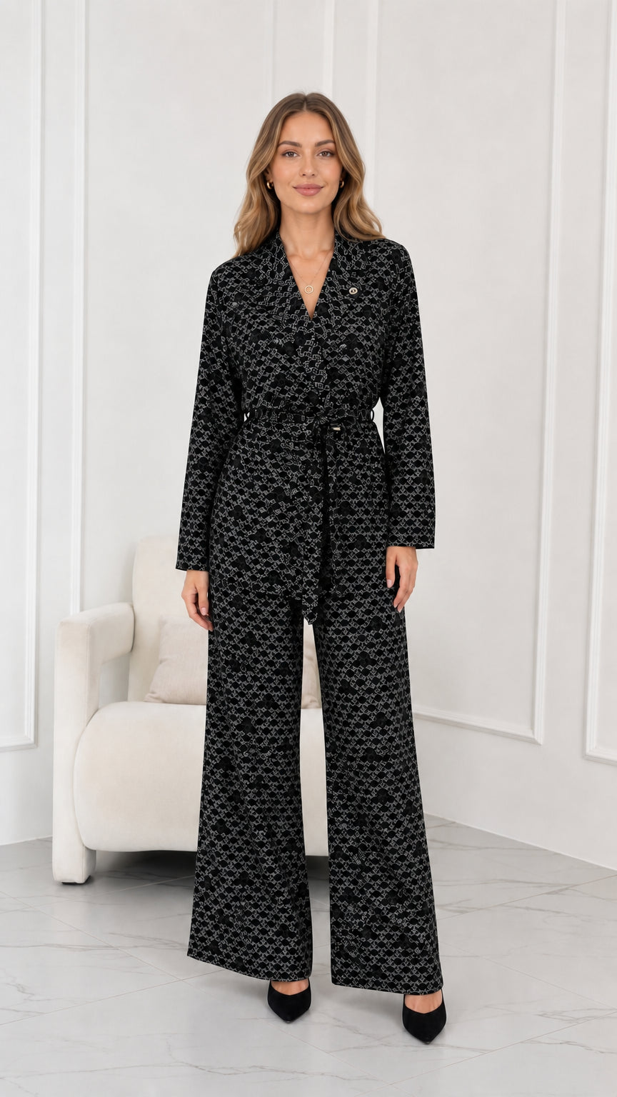 Model wearing black geometric print belted suit set with wide-leg trousers