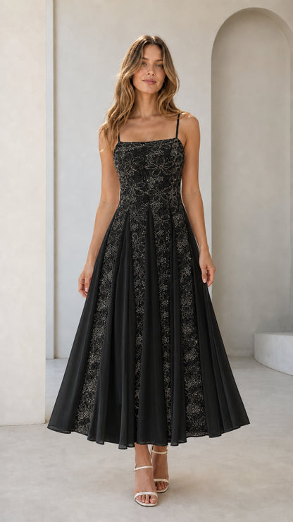 Front view of black floral embroidered midi dress on model
