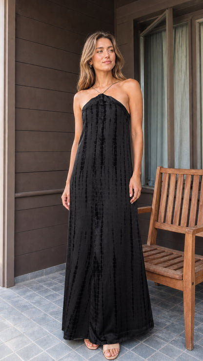 Front view of black tie-dye halter maxi dress