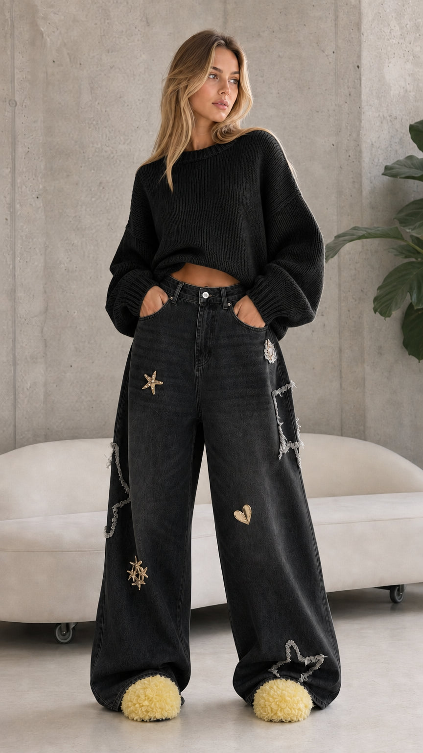 Full front view of washed black star embroidered wide leg baggy jeans with black sweater