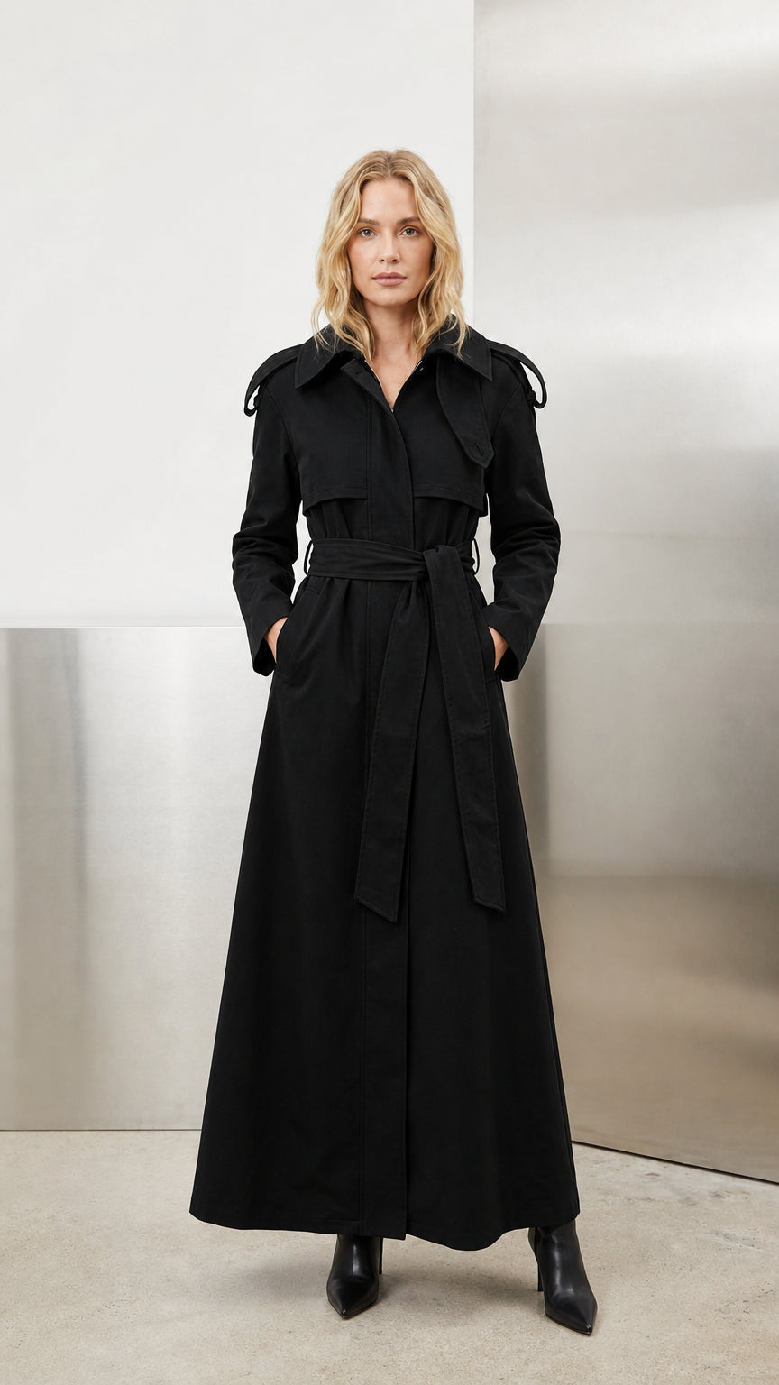 Model wearing classic black full-length belted maxi trench coat