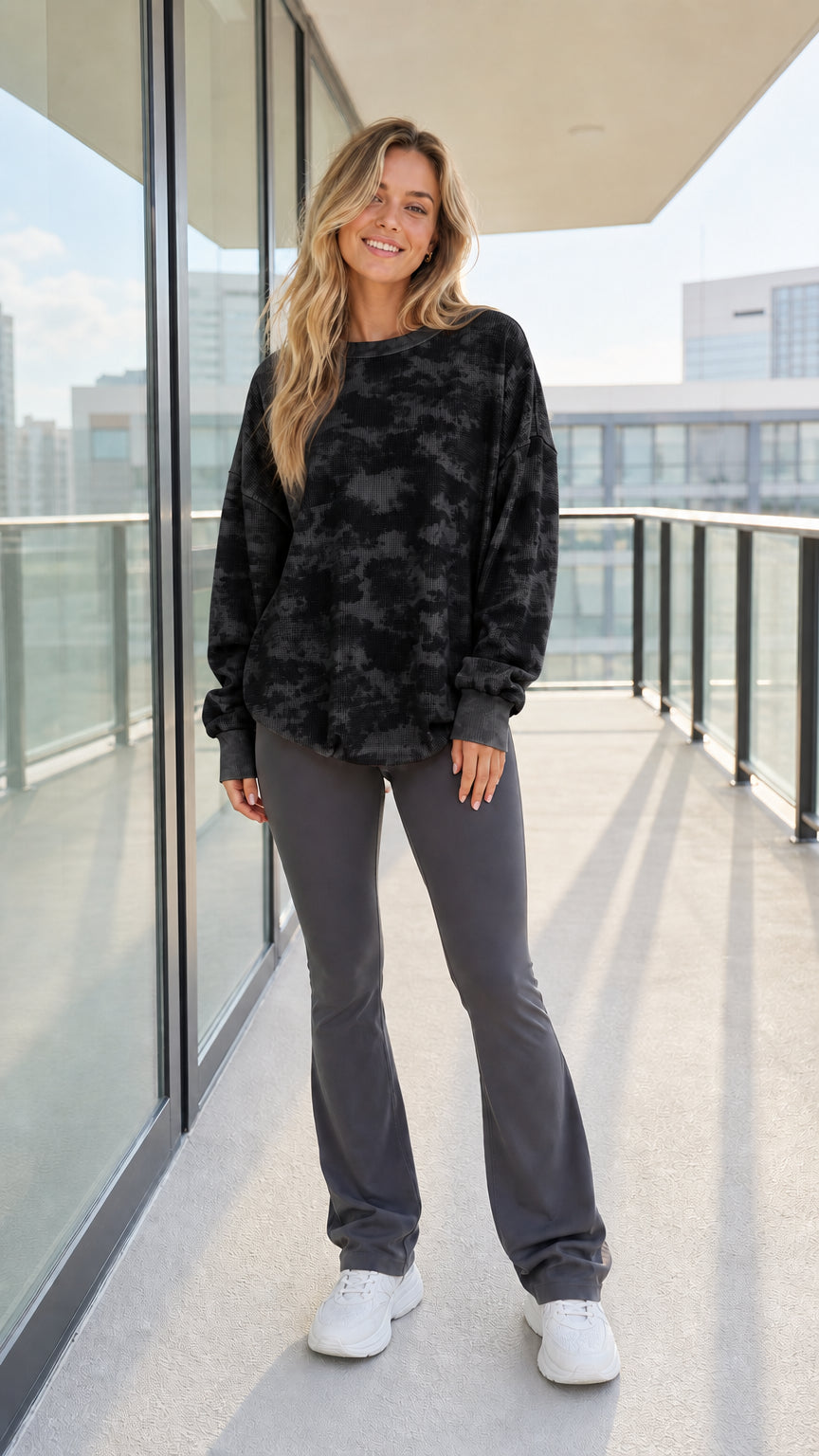 Woman wearing black and charcoal tie-dye waffle knit sweatshirt
