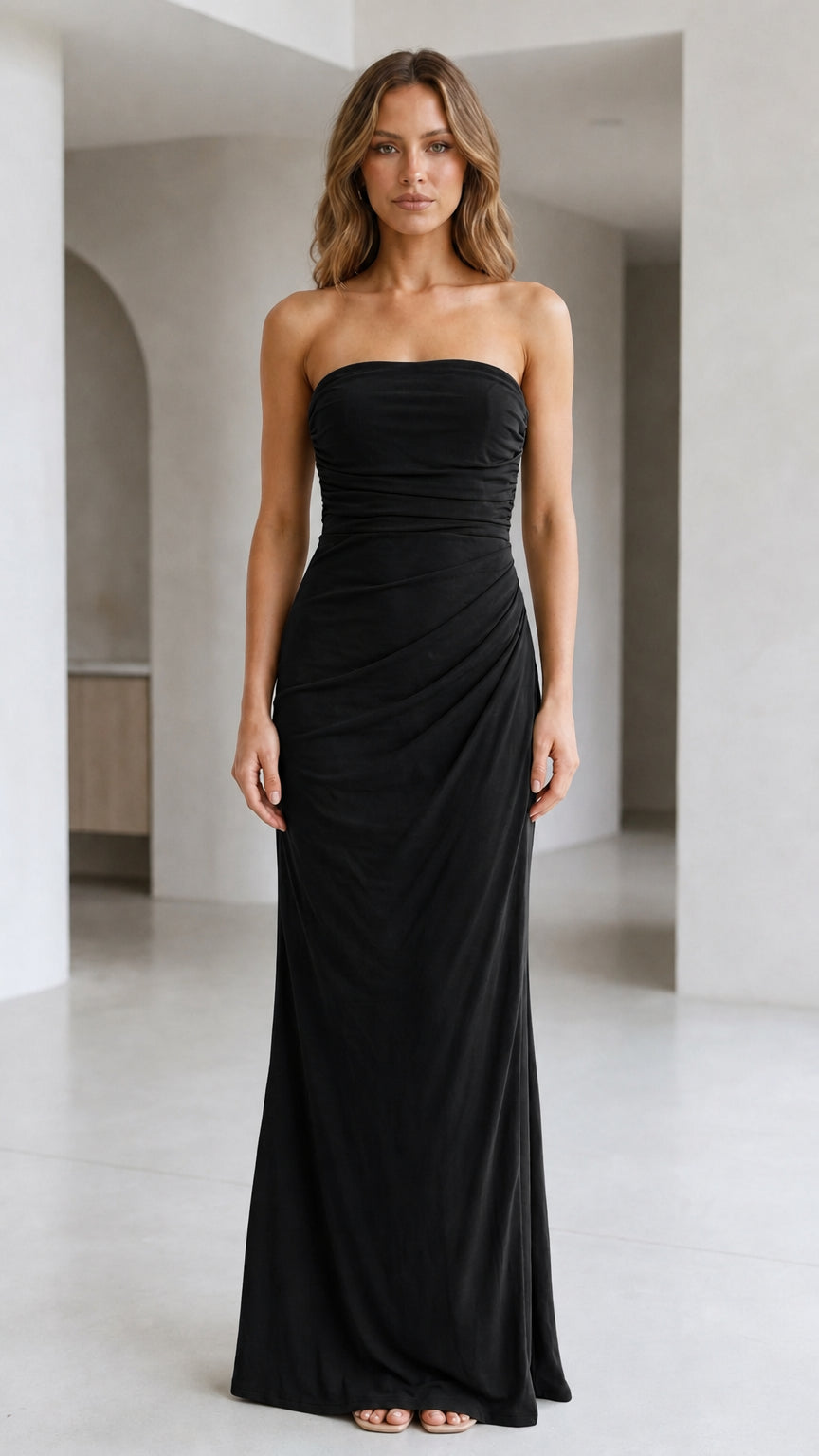 Front view of woman wearing strapless ruched maxi dress in black