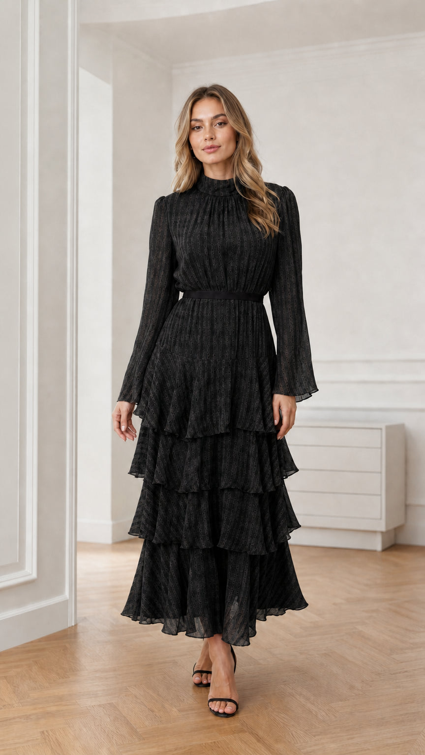 Model wearing black long sleeve tiered mock neck maxi dress