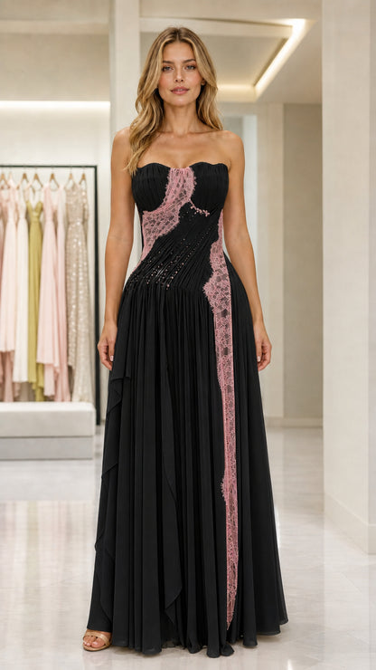 Front view of black strapless pleated evening gown with pink lace detail