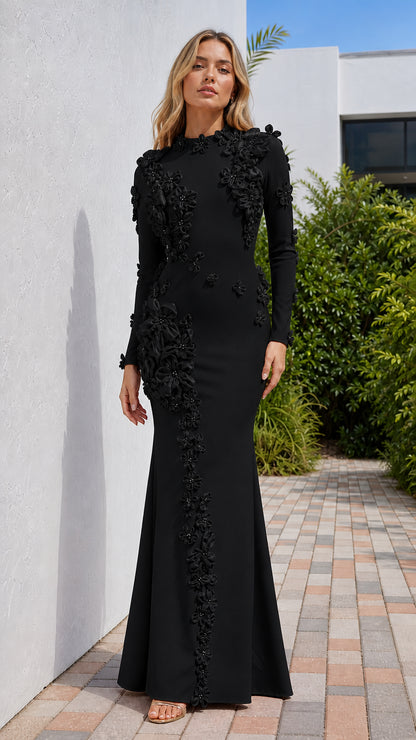Front view of model wearing black long sleeve evening gown