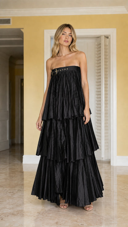 Front view of model wearing black strapless tiered pleated maxi dress