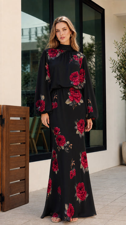 Full-length front view of woman wearing black floral print high-neck long sleeve maxi dress